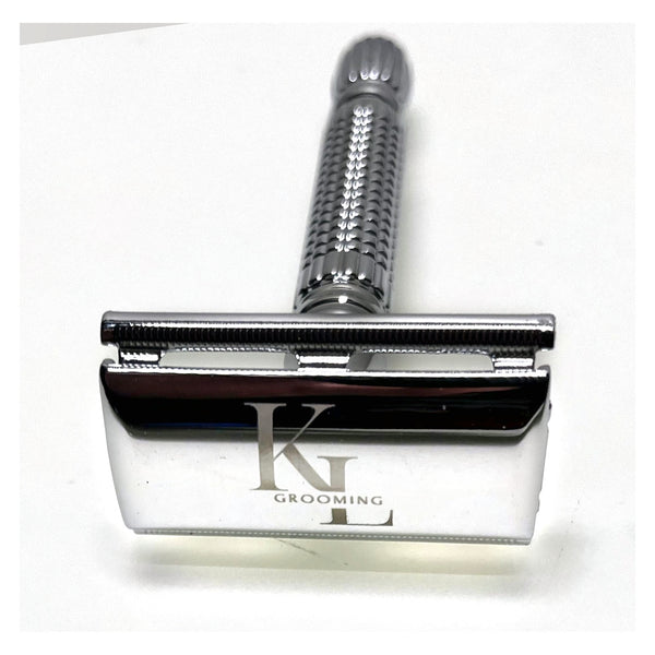 A silver metal safety razor with a textured handle and a polished blade engraved with the brand name 'KL GROOMING', shown on a plain white background.