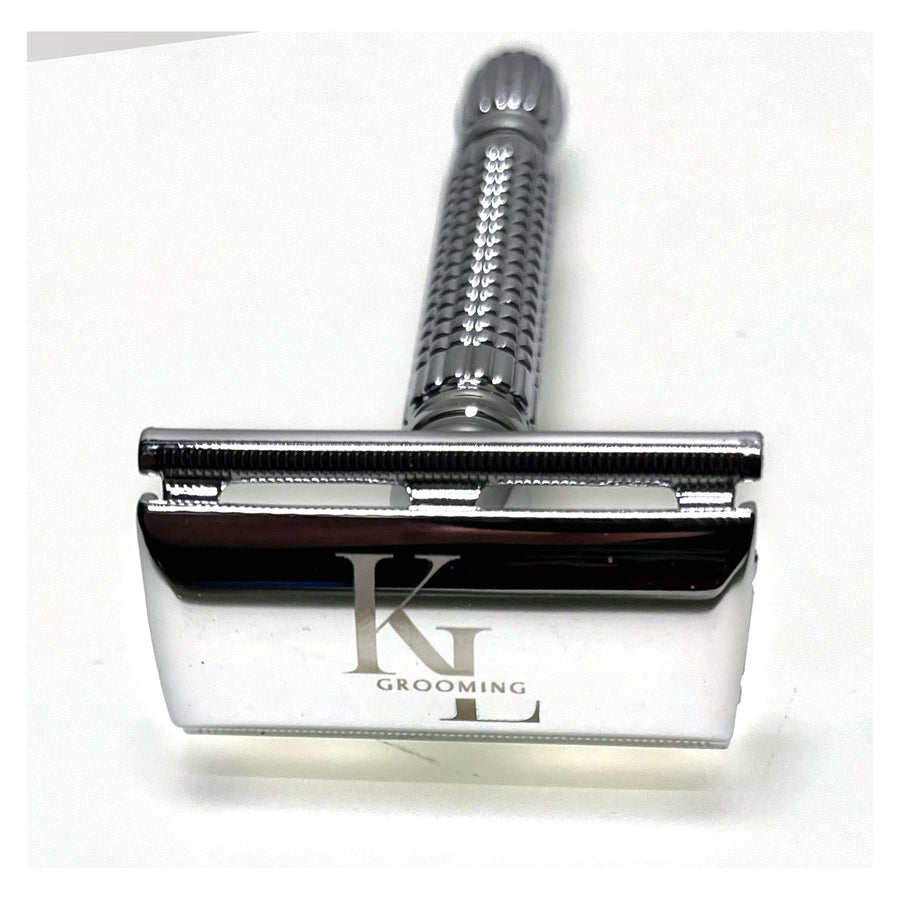 A silver metal safety razor with a textured handle and a polished blade engraved with the brand name 'KL GROOMING', shown on a plain white background.