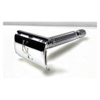 A polished chrome safety razor with a textured handle and a prominent 'KL' logo engraved on the guard, set against a plain white background.
