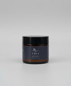 Two bottles of 'Kings & Lotus 1911' products on a wooden surface with a blurred background.