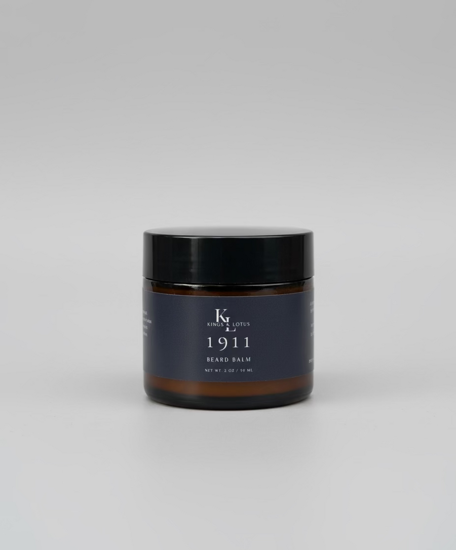 Two bottles of 'Kings & Lotus 1911' products on a wooden surface with a blurred background.